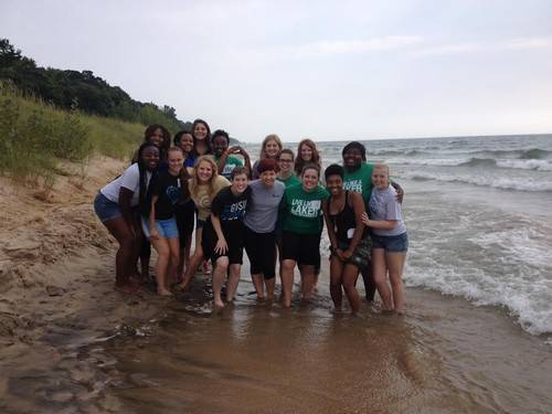 Group picture on the beach of all the women ant the women's leadership house